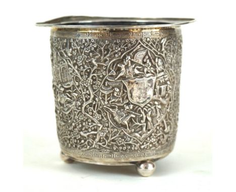 A Chinese silver bottle holder, Circa 1900 
Of cylindrical form with everted rim, raised on three tripod ball supports, the e
