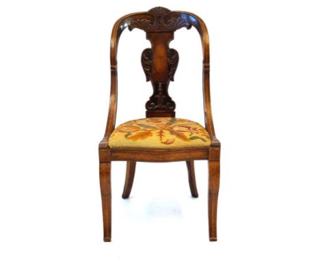 An elegant Empire style single chair, 19th Century
The carved and inlaid walnut frame featuring a fan and foliate crest above