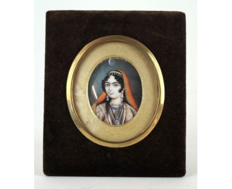 An Indian ivory portrait miniature, Circa 1880 
The oval portrait, painted depicting an Indian Princess wearing headdress and