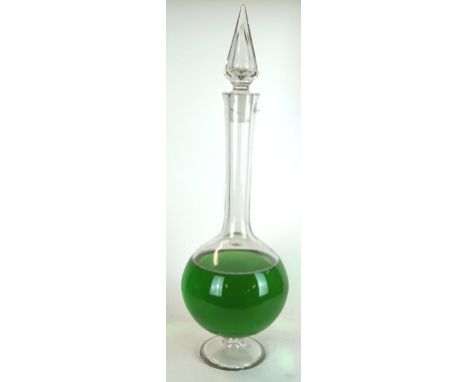 A Victorian glass apothecary chemist carboy
Of bulbous form with elongate cylindrical neck and diamond cut stopper, originall