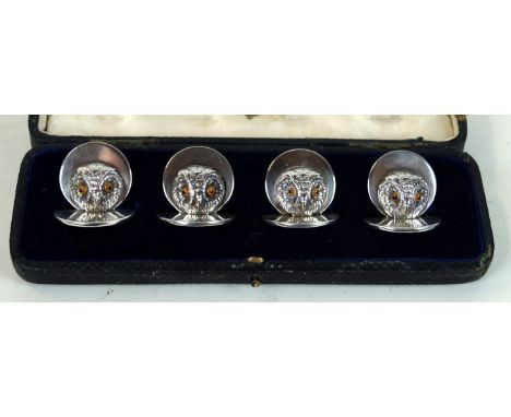 An Edwardian silver set of four novelty menu holders
Realistically modelled as owl heads, with enamel eyes and engraved detai