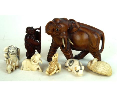 A collection of Japanese ivory netsuke and carvings
To include a carved wooden figure of an elephant, 10cm high, a small carv