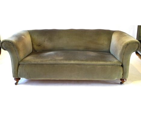 A Victorian Chesterfield sofa
Re-upholstered in an olive green draylon, raised on four solid turned oak feet terminating on b