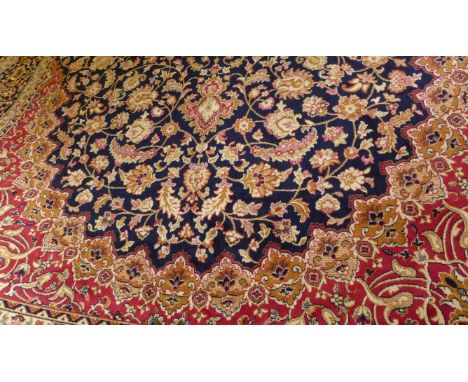 A Keshan carpet
On a manlily blue ground, central panel with florally decorated lozenge, flanked by matching floral decoratio