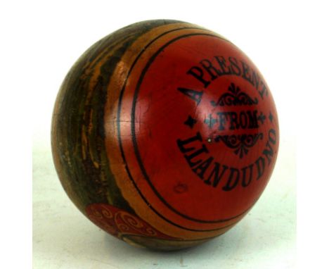 A late 19th/ early 20th Century tourist ware ball
Entitled a present from Llandudno, depicting two children playing and views