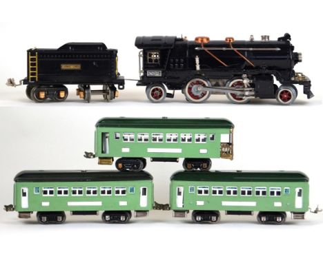 A Lionel 'O' gauge 2-4-2 locomotive
No. 262E with eight wheel twin bogey tender in black livery, together with a set of three
