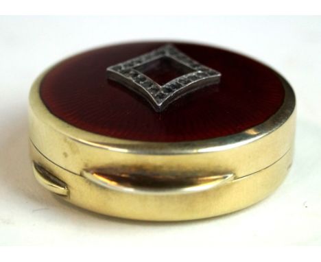 A Russian diamond set, silver-gilt and guilloché enamel pill box
Of circular form, the lid with red enamel decoration, with a