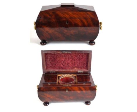 A Victorian flame mahogany tea caddy
Of rectangular form with two applied gilt brass handles, the interior enclosing two maho