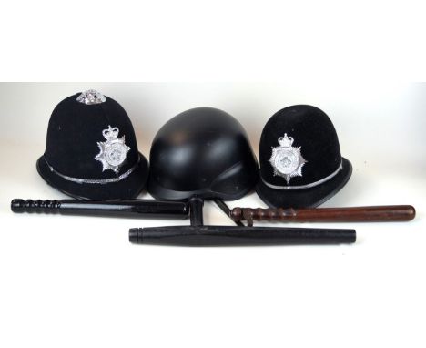 Two North Yorkshire police helmets, 20th Century
A hardwood police truncheon with leather strap, black painted night stick an