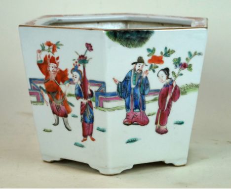 A Chinese 20th Century famille rose planter
The six sided tapered vessel, raised on scalloped bracket feet, painted in typica