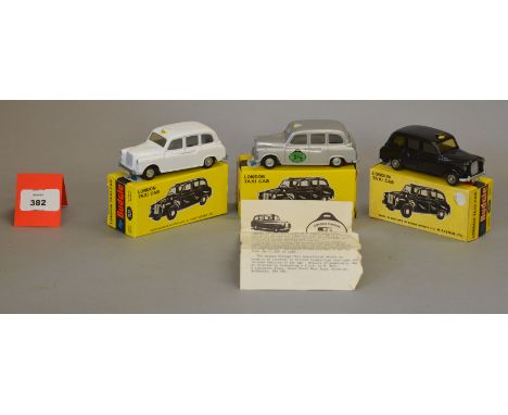 Three boxed Budgie Toys diecast # 101 FX4 Taxi models in black, white and silver, the latter being #924/1000 models, with cer