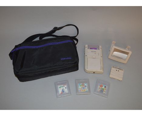 Nintendo Game Boy handheld console, together with battery adapter, light magnifier and four games (Tetris, Bugs Bunny Crazy C