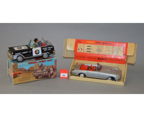 Two boxed battery operated tinplate toys, a  'Secret Agent Car' by TN Toys (Nomura Japan) together with a 'Ferrari Gear Shift