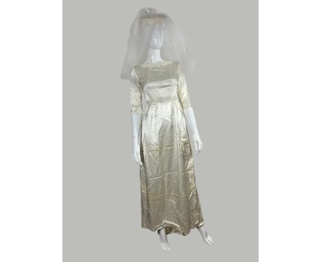 A 1960s satin wedding dress, bracelet length sleeves with guipire trim with a train complete with its veil. Fenwick label and