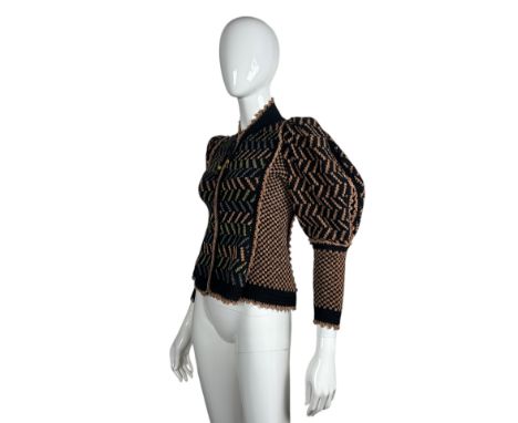 A zip front cardigan or jacket by British designer Anne Fewlass made from black wool with a broken chevron stripe in apricot,