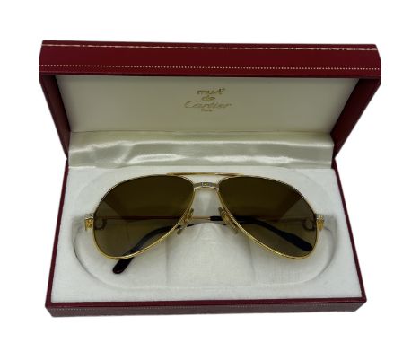 A pair of late 70s/ early 1980s aviator style sunglasses by Cartier in their original presentation box. (1)  excellent condit