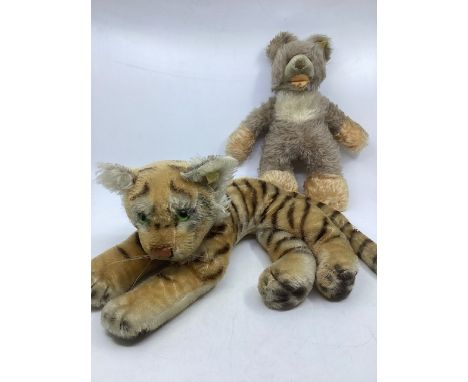 Vintage steiff 1960s toys with button and yellow cloth tags to include a recited tiger with chest tag c 14ins long and a baby