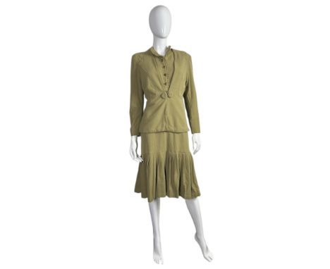 A post war 1940s dinner plate / double elevens label dress in a mossy green moss crepe the dress having piecrust pleat detail