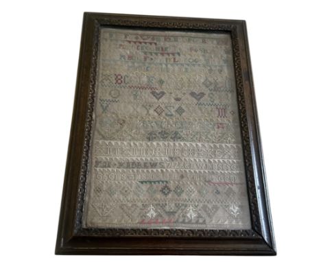 A 19th century alphabet sampler with embroidery in silk, cotton and metal threads on a linen ground. The alphabet, in upper c