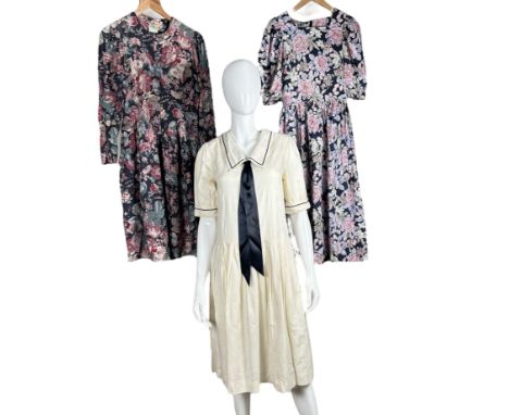 Three Laura Ashley dresses to include a 1980s sailor style dress in a linen/ cotton blend damask with subtle rose motifs, a c