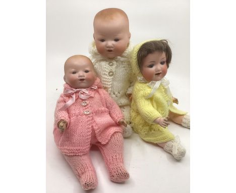 Antique German bisque head baby dolls ; to include a 13” bisque head Marseille 351 Dream Baby in white knitted pram set, a 10