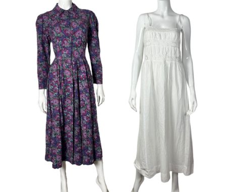 A 1980s Laura Ashley tea dress in a cotton and wool blend fabric with a floral print in cerise, lilac and lavender on a navy 
