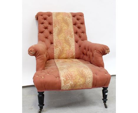 A Victorian button-back fireside chair upholstered in a pink woven material, central foliate panel on carved and turned mahog