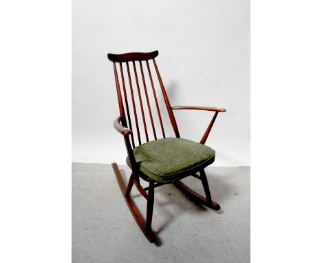 An Ercol dark stained stick-back rocking chair with label to seat.