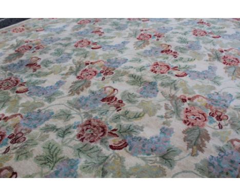 A large machine-made wool floral decorated cream ground carpet with floral border, approx 300 x 240cm. CONDITION REPORT No ob