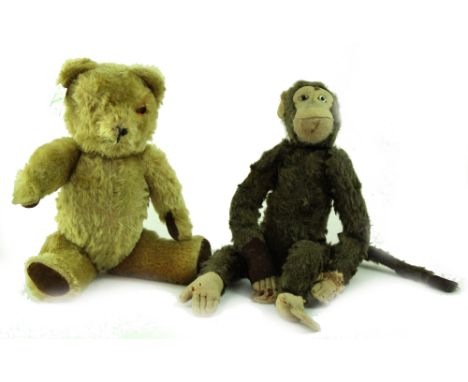 A vintage straw-filled teddy bear with articulated limbs (missing one eye) and a c1920s straw-filled monkey, height 44cm (bot