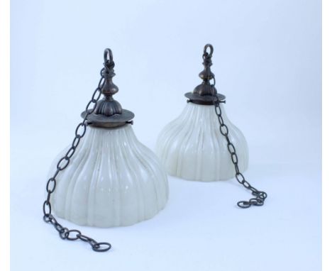 A pair of vintage ceiling mounted lights with vertical fluted off-white glass shades suspended by chain. CONDITION REPORT Ove