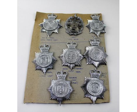 A board of eight plated Police helmet badges to include Leeds City Police helmet plate, possibly pre-WWII.