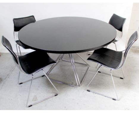 A vintage Mira table and four chairs, the table with circular black ash top on triangular chrome supports, diameter 130cm, th