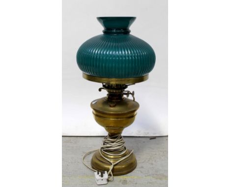 A brass oil lamp converted to electric, with green shade, height 48cm.