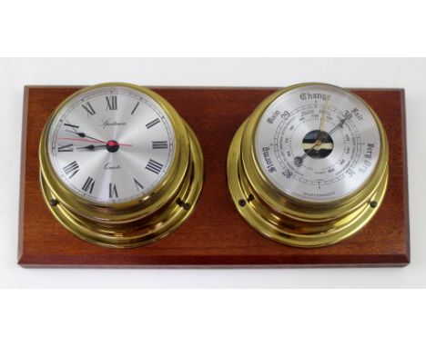 A Spectrum quartz porthole style clock and barometer set mounted on mahogany plinth, length 36cm. CONDITION REPORT Working ju