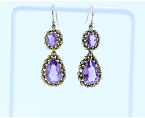 A pair of yellow metal drop earring set with amethyst in beaded surround. CONDITION REPORT OK condition, patch of repair to t