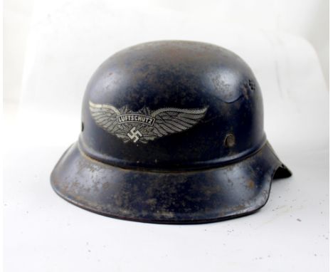 A WWII German Luftschutz helmet with complete decal. CONDITION REPORT In poor to average condition.