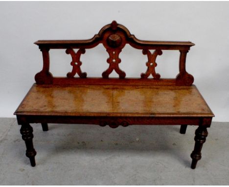 A 19th century and later bench, the ornate arched top back with pierced splats rests on a burr walnut seat, raised on oak tur