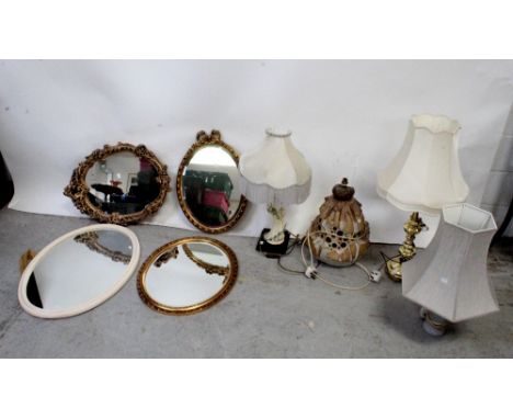 A Studio pottery table lamp with pierced circular design and three other modern table lamps, a Rococo-style oval wall mirror 