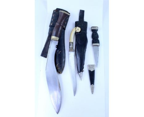 Three vintage ceremonial daggers including a 19th century Middle Eastern Janbiya with ivory handle, bird's head to the handle