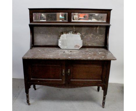 A Victorian rouge marble top wash stand, rectangular mirror above single shelf to marble top over two cupboard doors to turne