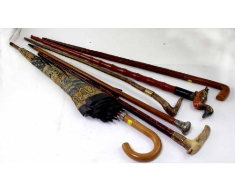 Six various walking sticks, canes and a vintage umbrella, to include horn and silver handles (6).
