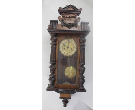An early 20th century mahogany Vienna-style eight-day wall clock, Classical columns and pediment over gilded and enamel dial 