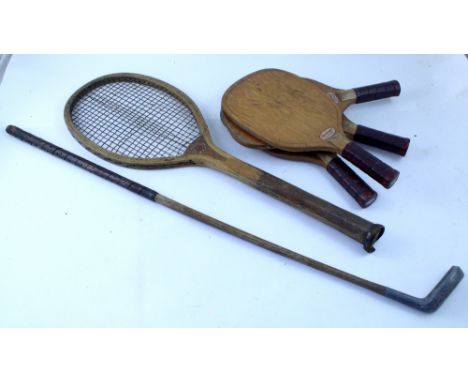 Four vintage Slazenger 'padder' bats, a Frank Sugg, Liverpool tennis racket and a vintage putter with hickory shaft (6). COND