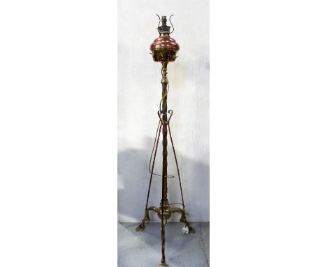 A Victorian brass and copper telescopic standard oil lamp, later converted to electric, the central twist column mounted with