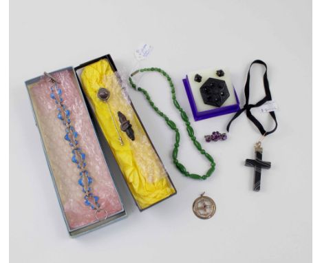 A Victorian agate cross on ribbon, Longfellows scarf pin, bog oak horseshoe brooch, jet brooch, green jade jellybean necklace