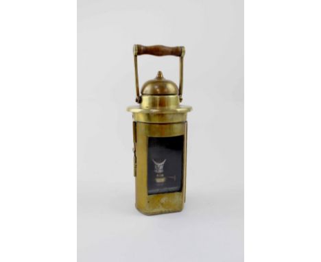 An early 20th century brass lantern with swing handle, the ceramic burner stamped 'Barton's Trademark', height with handle ex