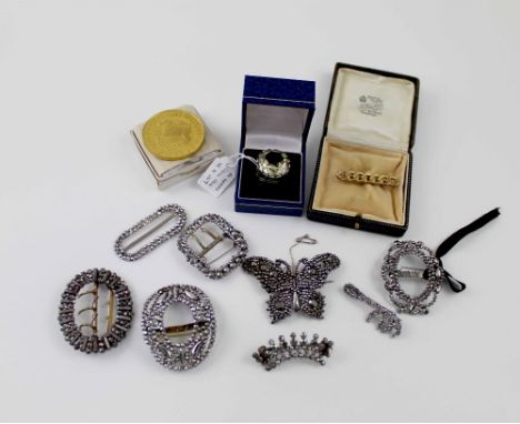 A quantity of costume jewellery to include cut steel buckles, brooches, gilt commemorative coin, silver gentlemen's ring set 