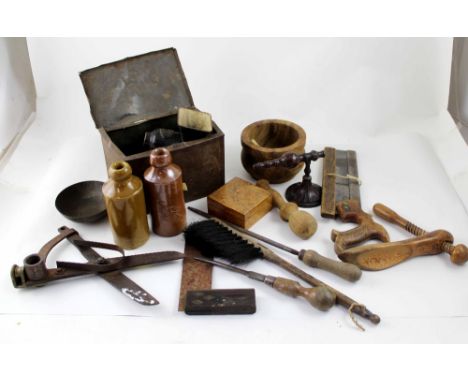 A box containing vintage tools, stoneware bottles, vintage clippers etc.