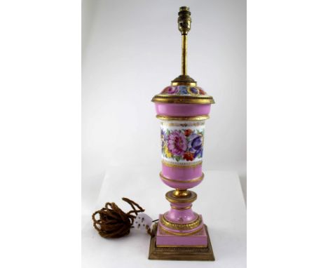 A 19th century porcelain lamp base, hand painted with flowers in gilt borders on a pink ground with gilt metal mounts, height